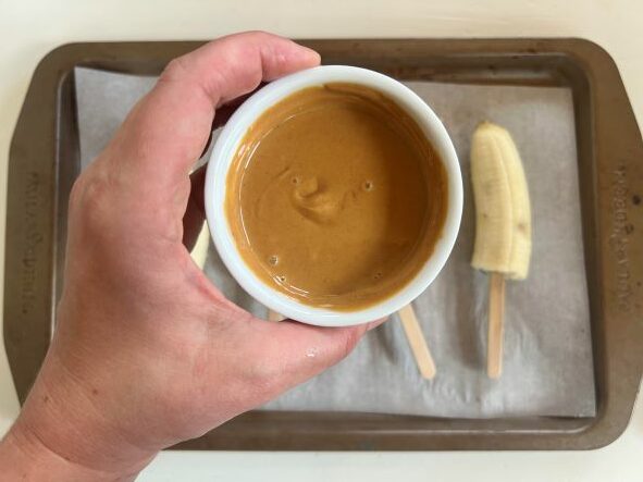 Melted peanut butter for frozen banana popsicles